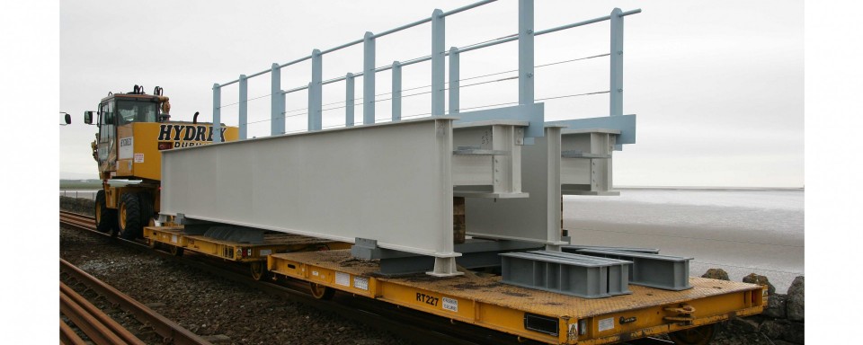 A bridge section arrives on a Road Rail Vehicle (RRV)