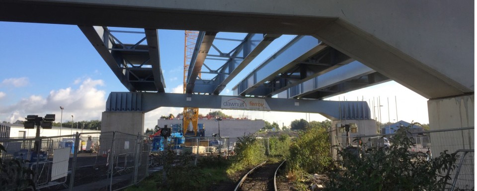 Over train line support for main deck girders