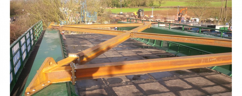 A bracket assembly bolted to the new bridge providing lifting points and stability 