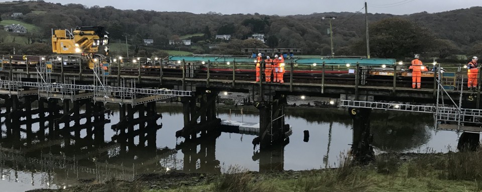 Temporary support girders being maneuvered in position