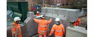 Contractors maneuvering a pilaster into place