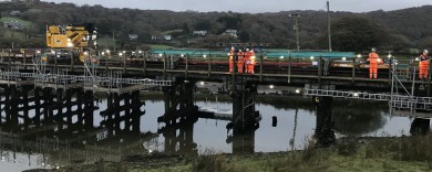 Temporary support girders being maneuvered in position