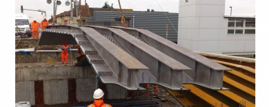 Streatham Common Station with contractors lowering the tripple 'I' beam arch into place